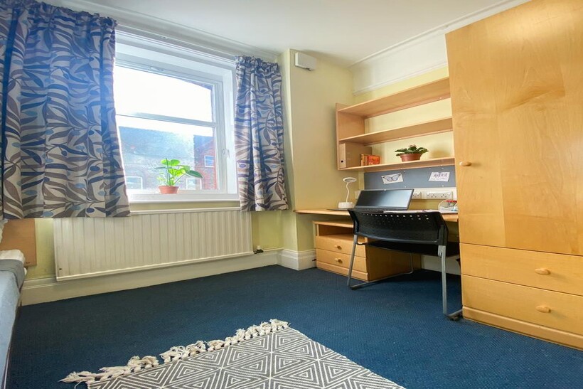 A bright and tidy double bedroom featuring a co...